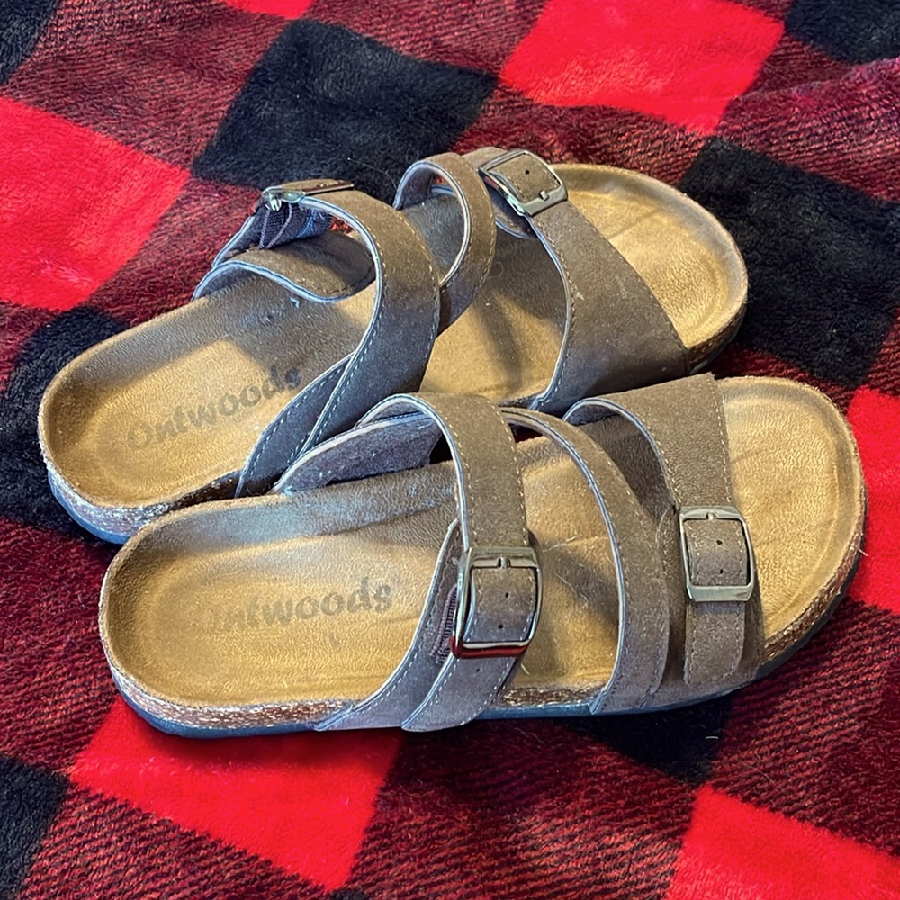 Dark brown faux leather sandals.